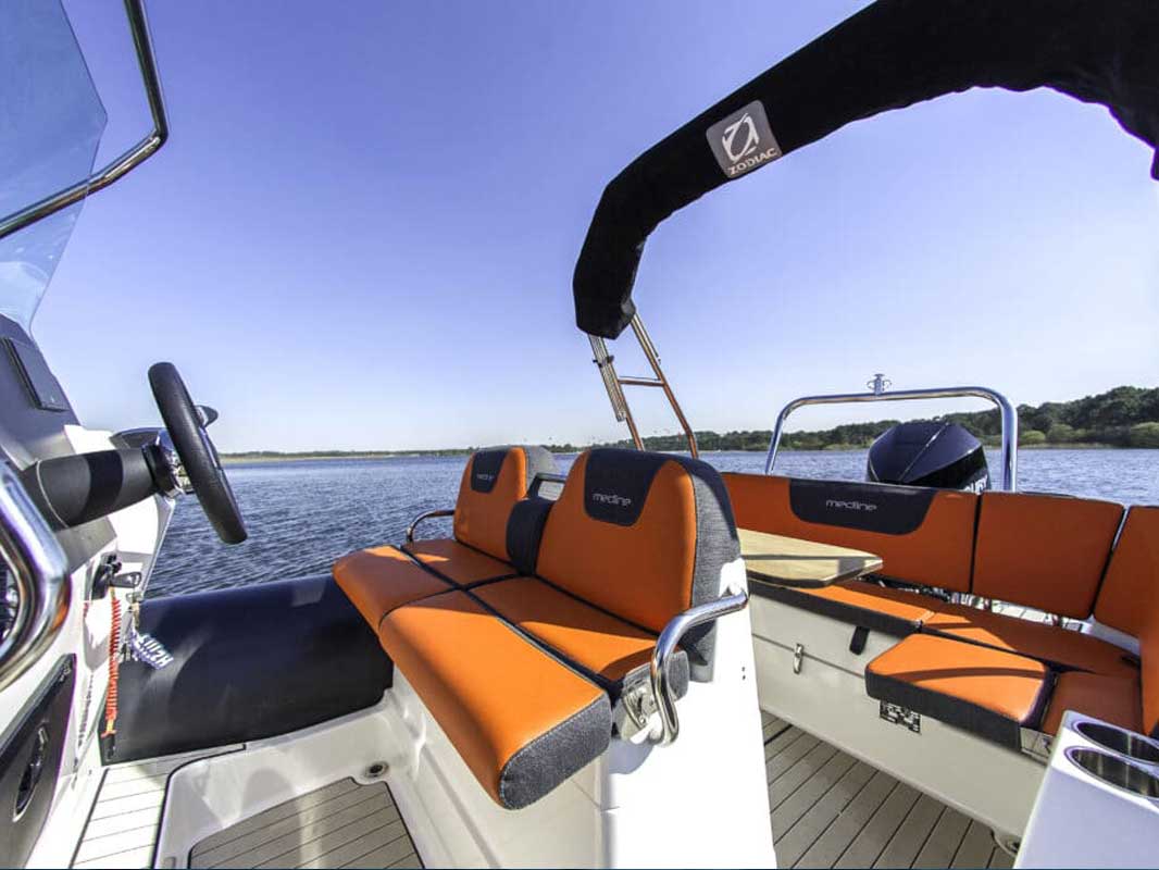 Thumbnail of http://Image%20of%20the%20interior%20of%20Zodiac%20Medline%206.8%20boat%20with%20vibrant%20orange%20accents,%20offering%20both%20style%20and%20comfort%20for%20passengers,%20with%20plenty%20of%20seating%20and%20storage%20space.